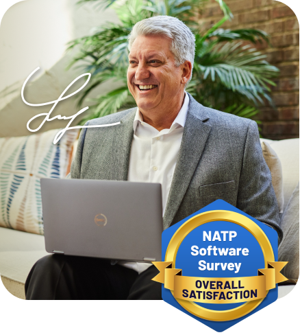 smiling older man sitting at computer