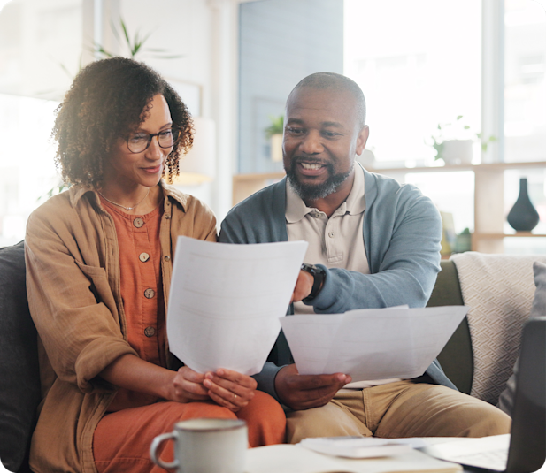 man and woman discussing over paper works