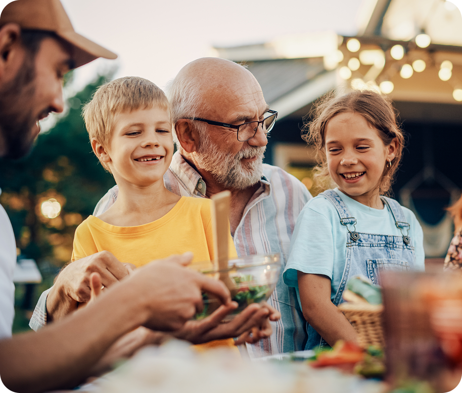 grandpa with glasses holding grandchildren