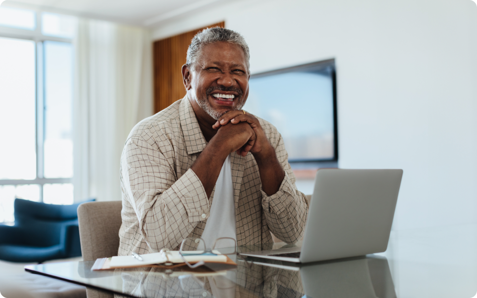 Smiling tax preparer at a desk with a laptop