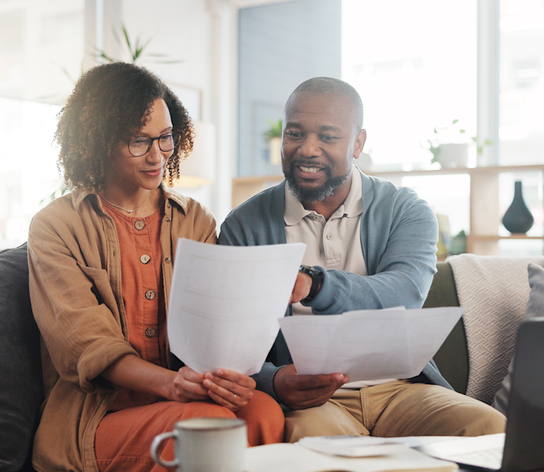 man and woman discussing over paper works