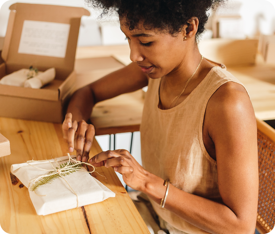 A lady wrapping gift at her desk