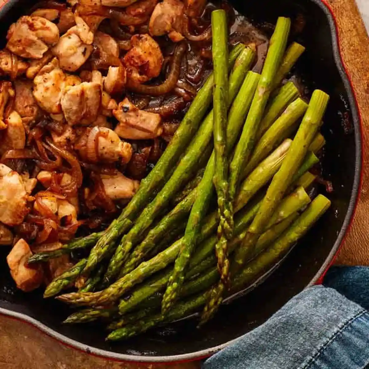 Skillet with diced chicken and asparagus