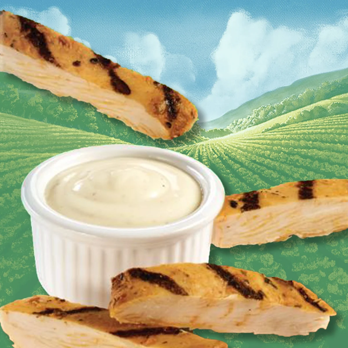 Chicken strips being dipped into a ramekin of buffalo ranch dressing. A valley and clouds in the background.