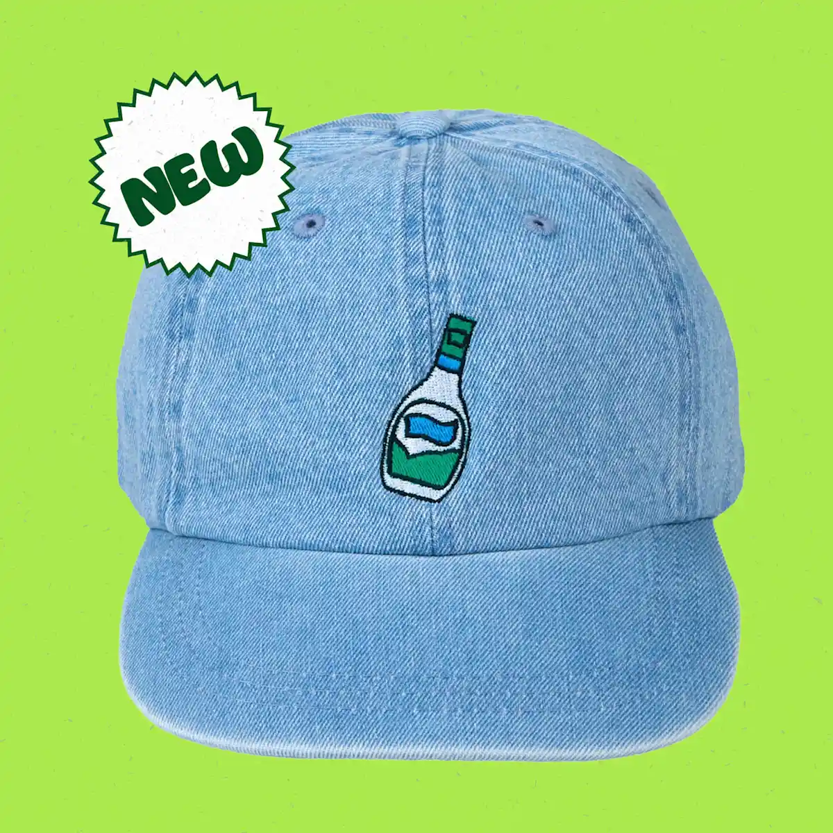 Denim cap with embroidered ranch bottle on a green background with a badge over it containing the word "New"