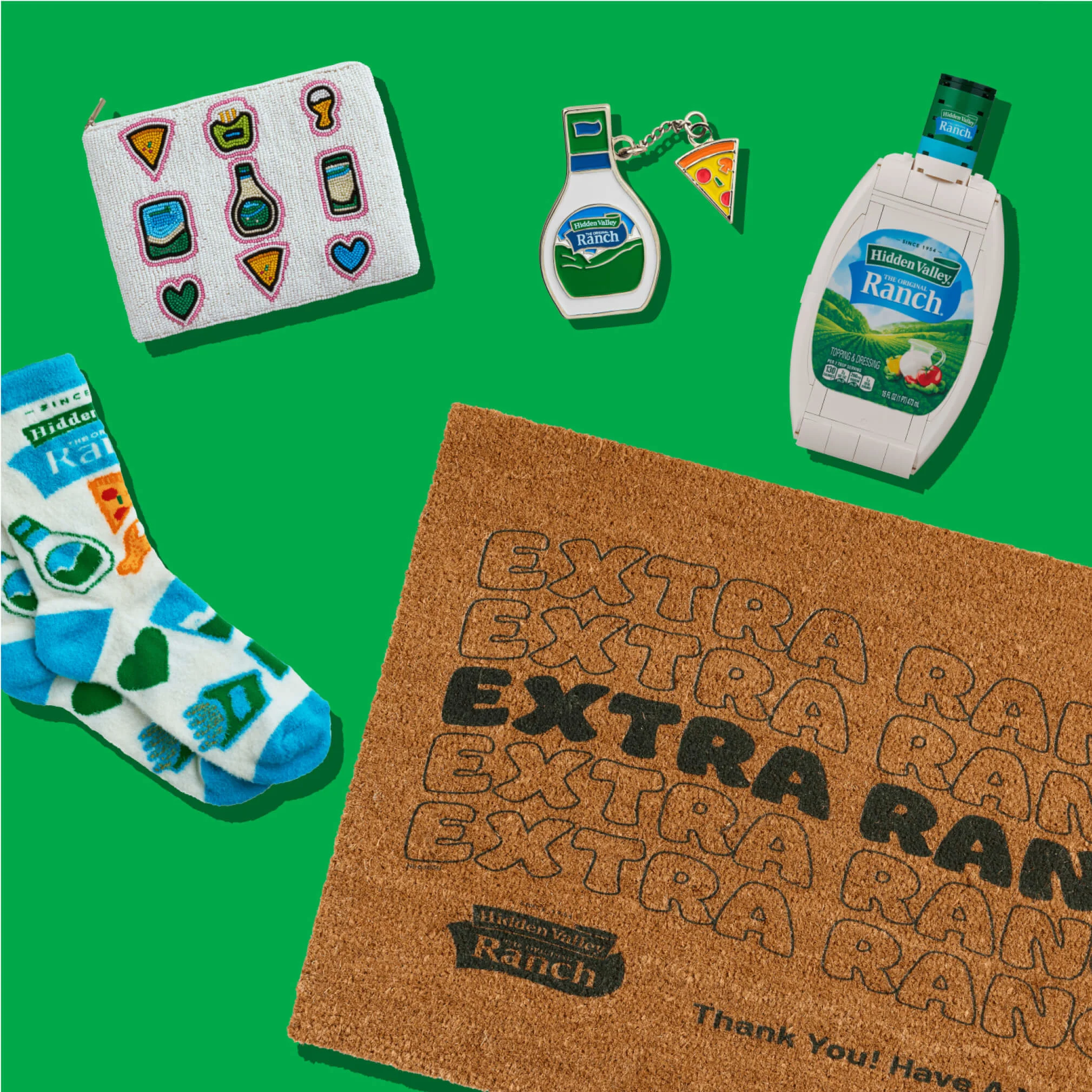 Hidden Valley socks, door mat, pin, clutch on a green background