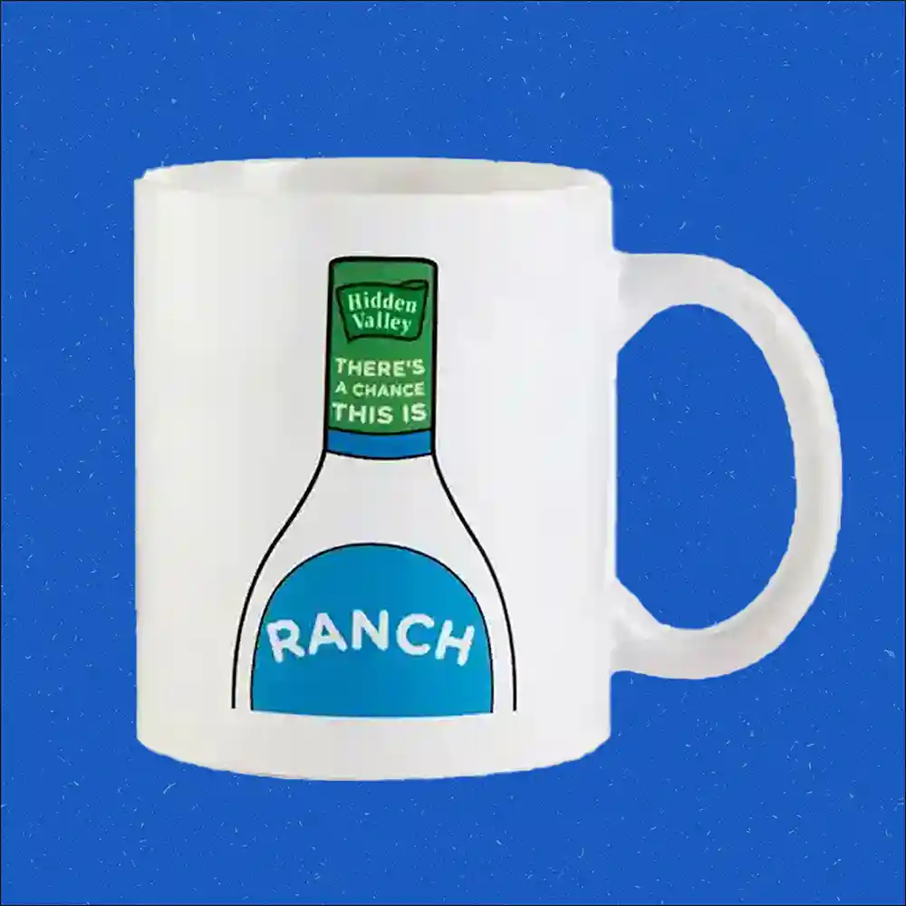 A white mug with an illustration of a Hidden Valley Ranch bottle on it