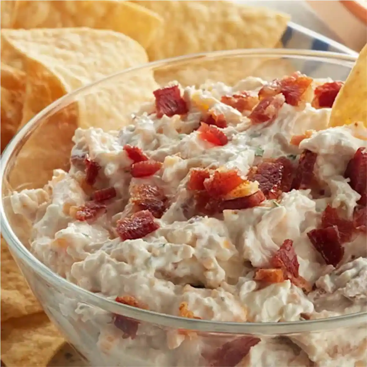Bowl of Crack Chicken Ranch Dip with chips in the background