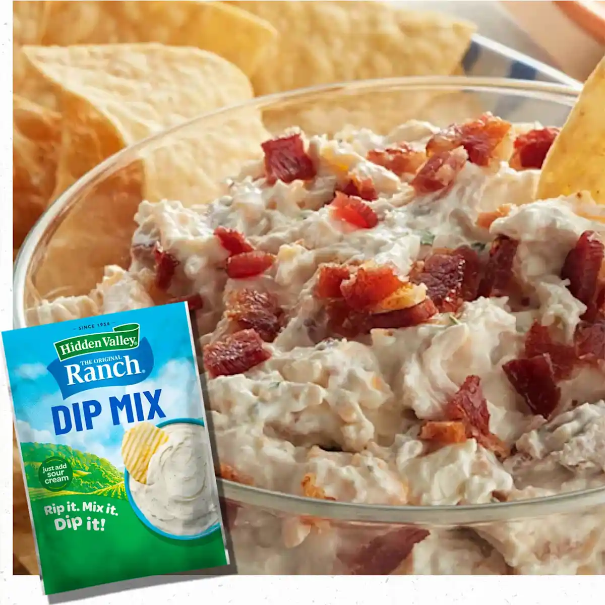 Bowl of Crack Chicken Ranch Dip with chips in the background
