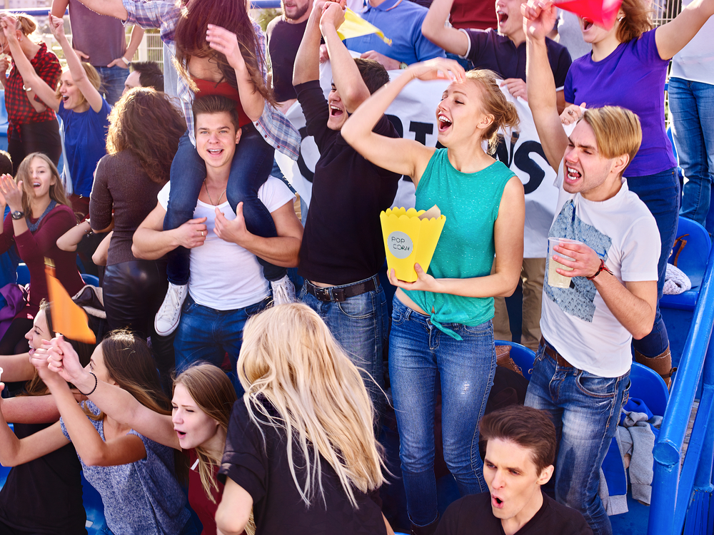 Sports-Fans-Enjoying-Food-and-Beverages-From-The-Concession-Stand 347580482