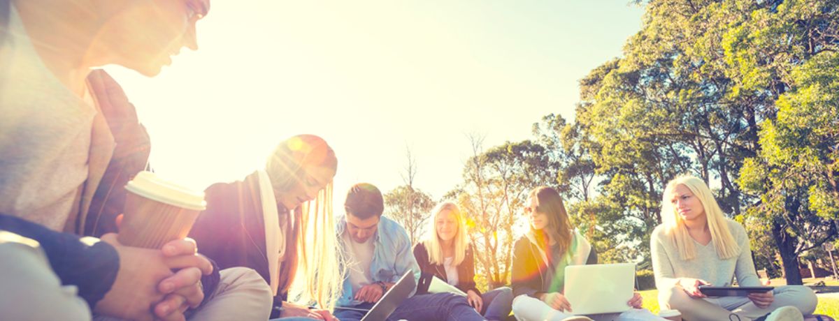 A group of young men and women sat in a circle discussing teenage developmental milestones