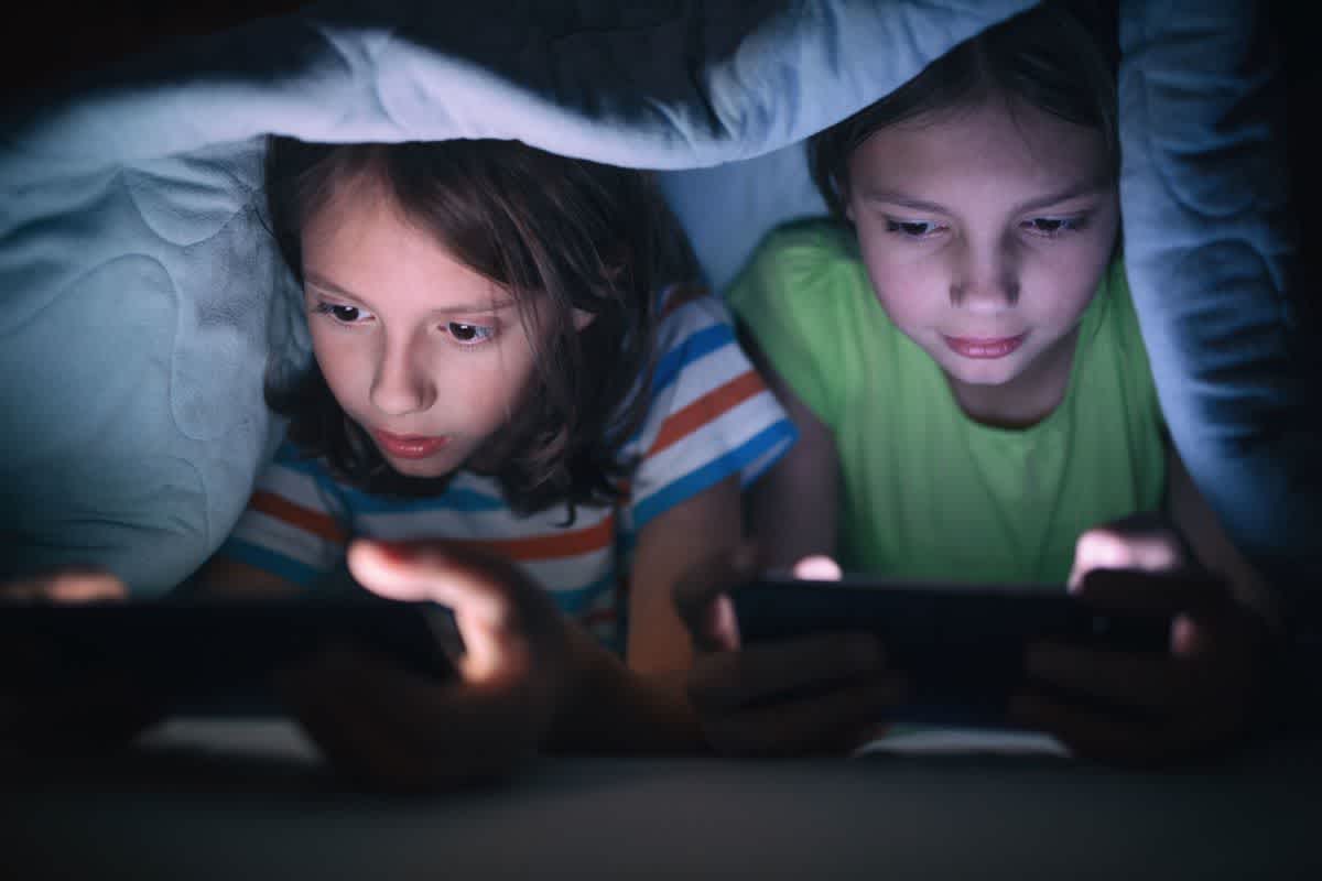 Children playing games on their phones prior to their parents deciding on limiting screen time for kids