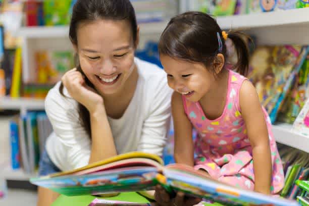 Mother supports her child in reading since learning how to boost your child's confidence
