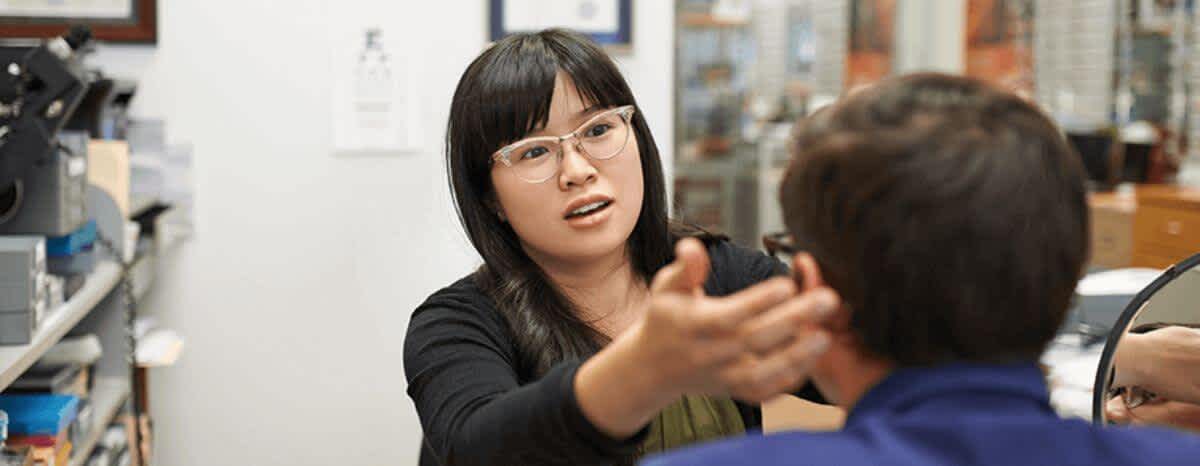 Male has glasses fitted by a female having asked himself do I need glasses