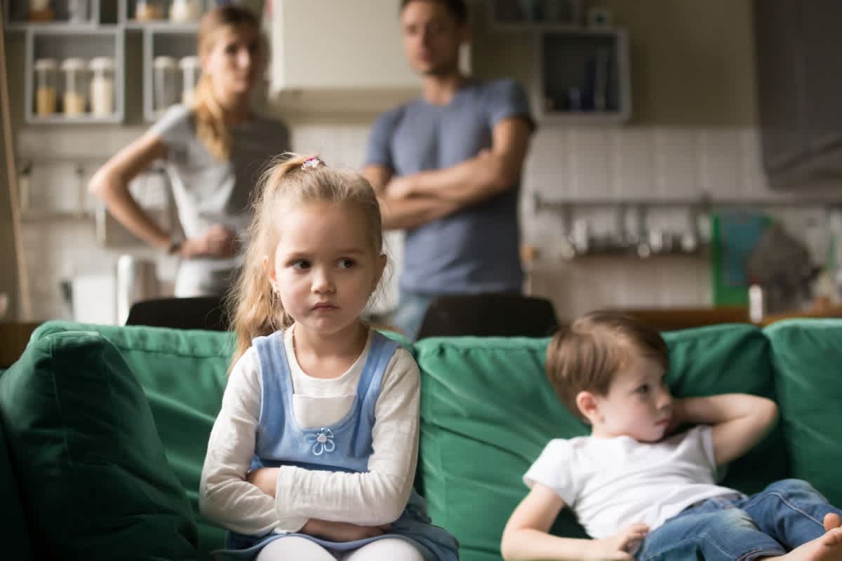 Young girl and boy are grounded to the couch as a way for parents managing childrens behaviour in their early years