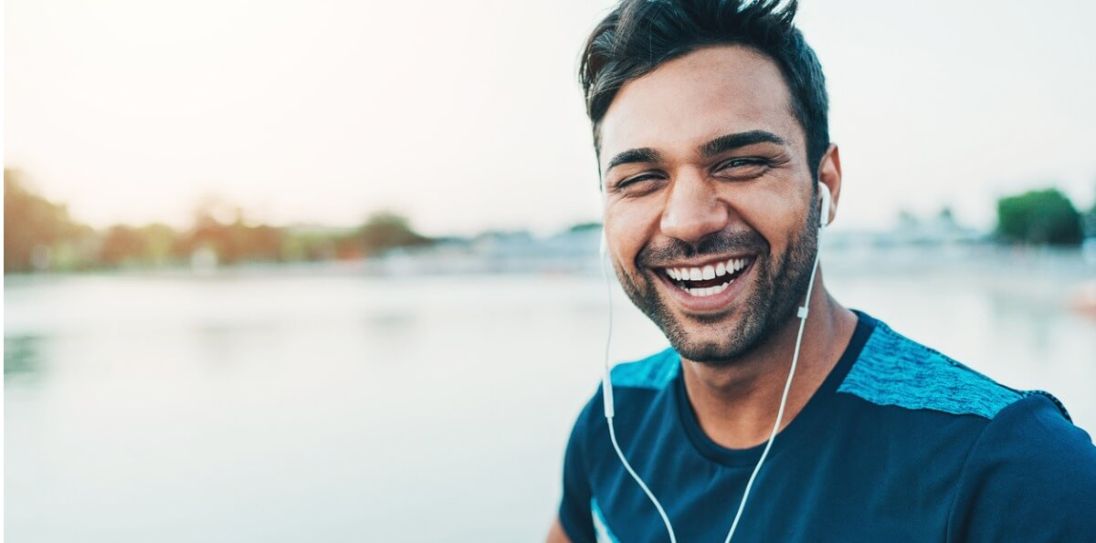 Happy young man smiling at the camera after he learnt how to boost your immune system