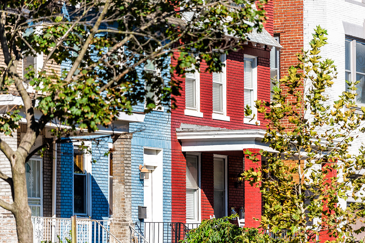 row of painted brick houses in urban neighborhood