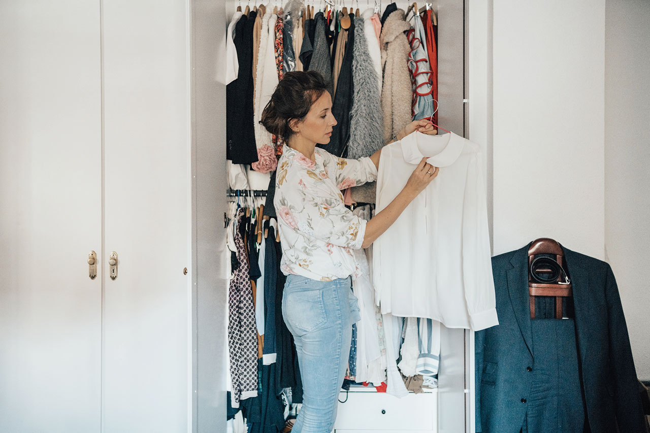 Woman organizing clothes in her closet