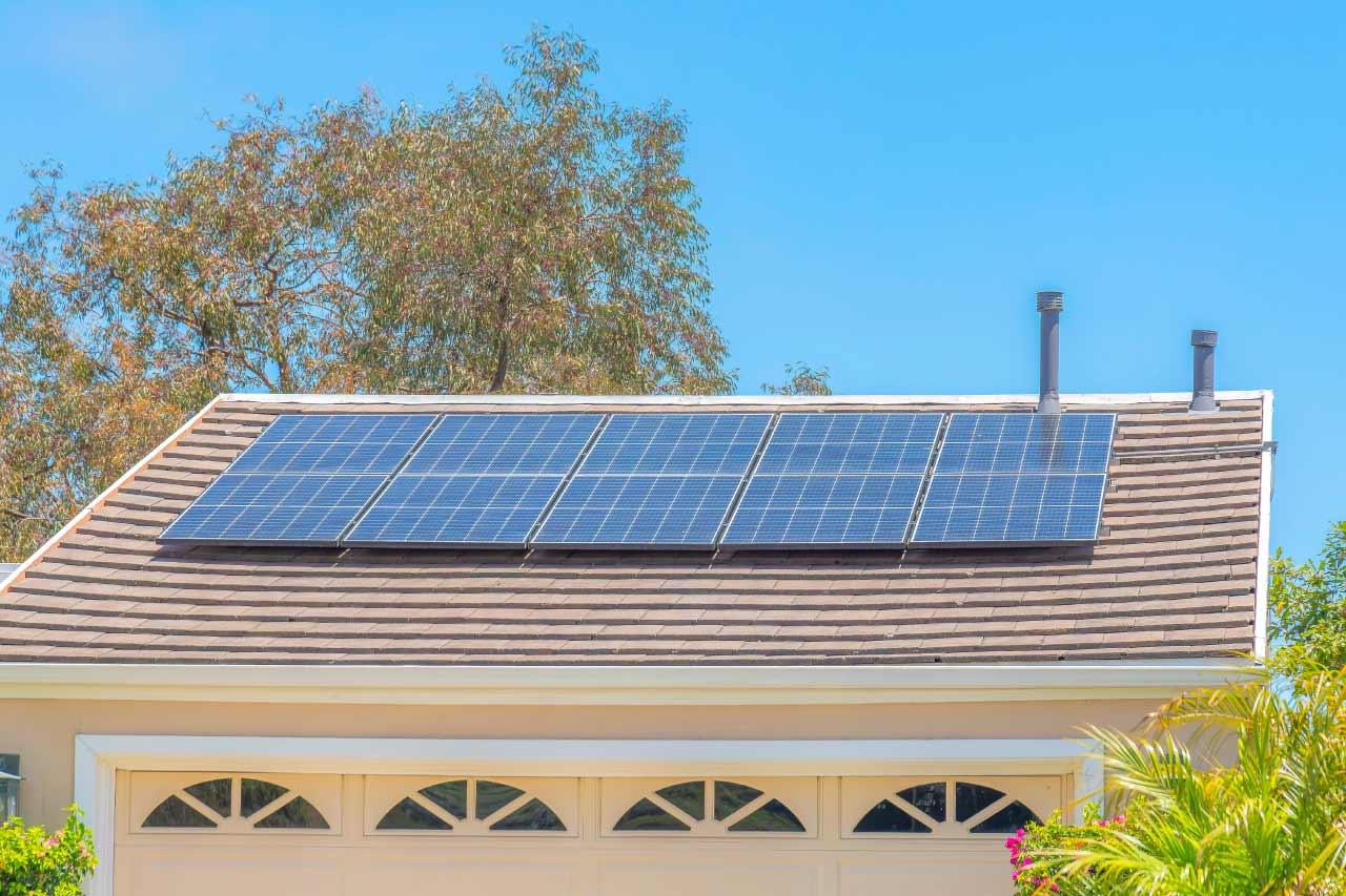 Solar panels on the shingles roof of a house