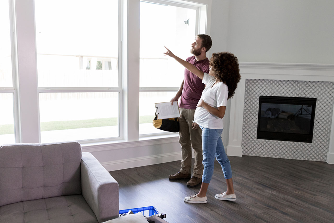 Man and woman looking at window lintel