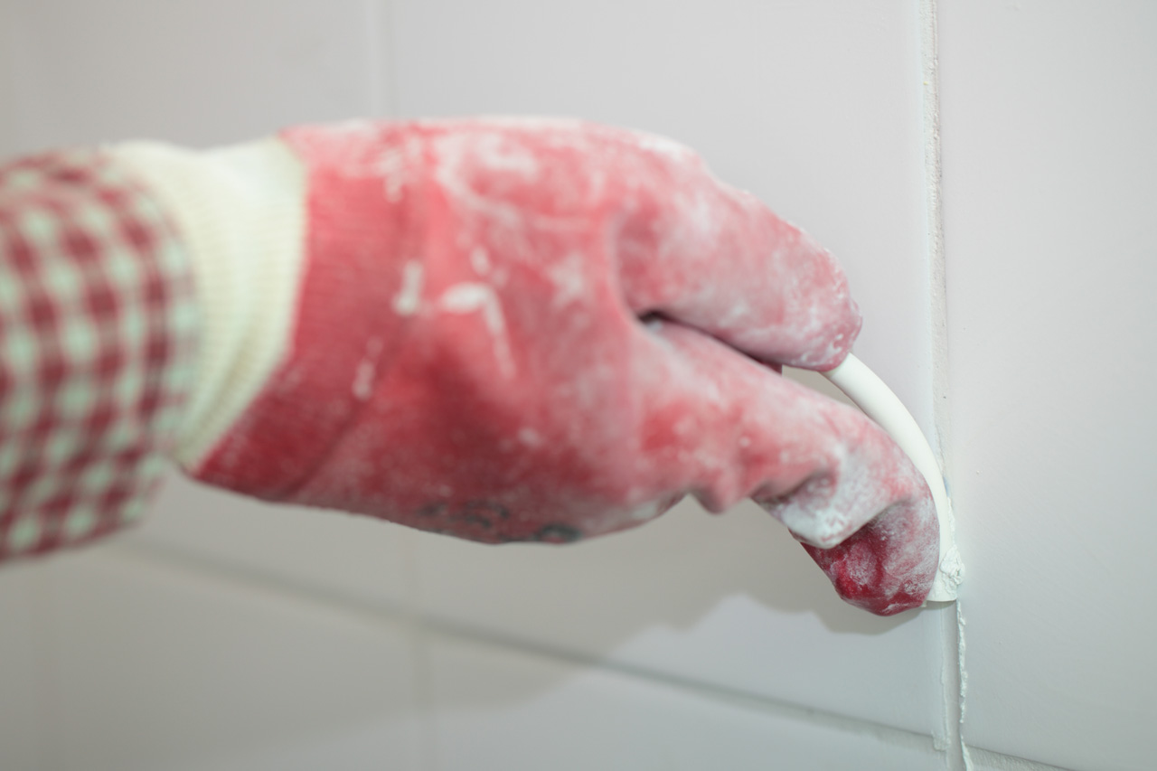 master bathroom shower wall being regrouted