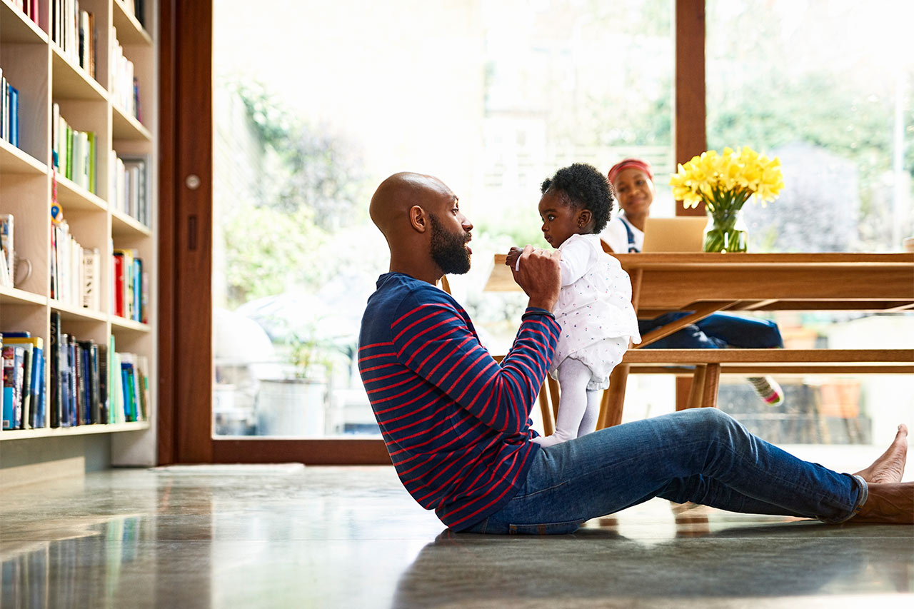 Family on living room floor by table
