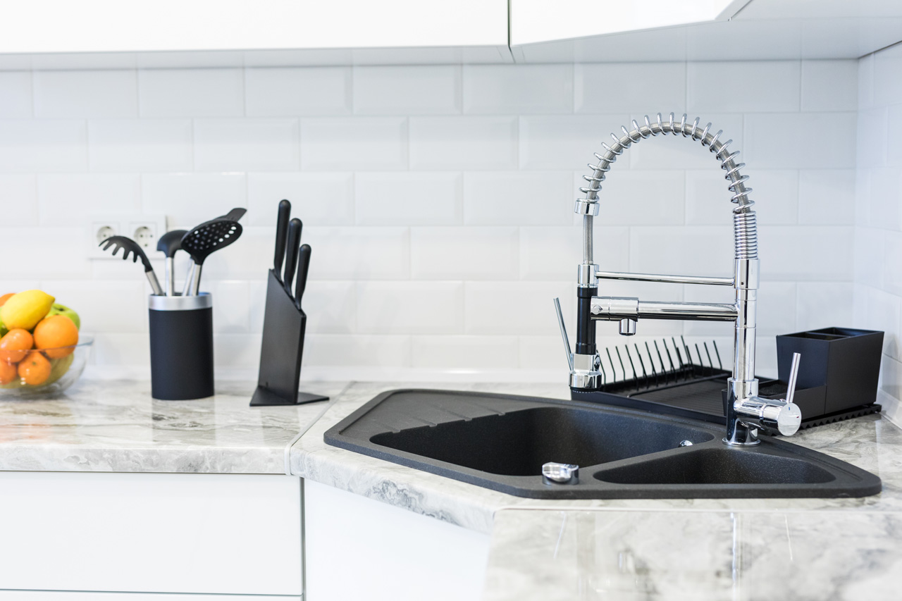 A fancy black sink in a modern kitchen
