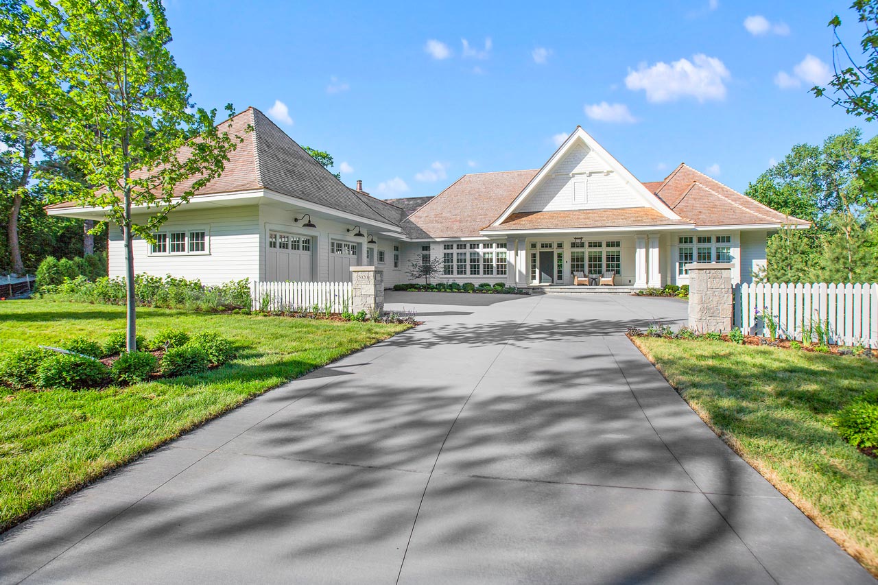 A beautiful home with a concrete driveway on a sunny day