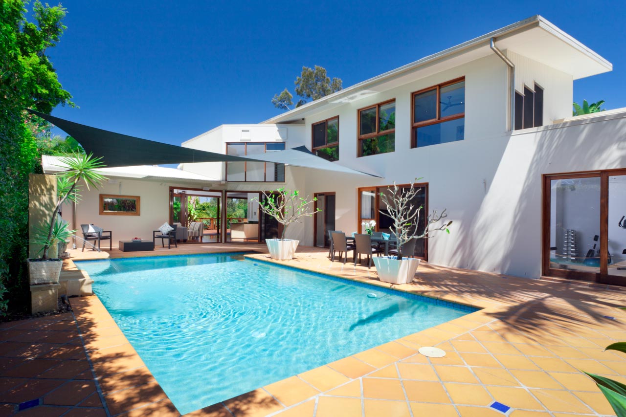 A rectangular swimming pool in backyard