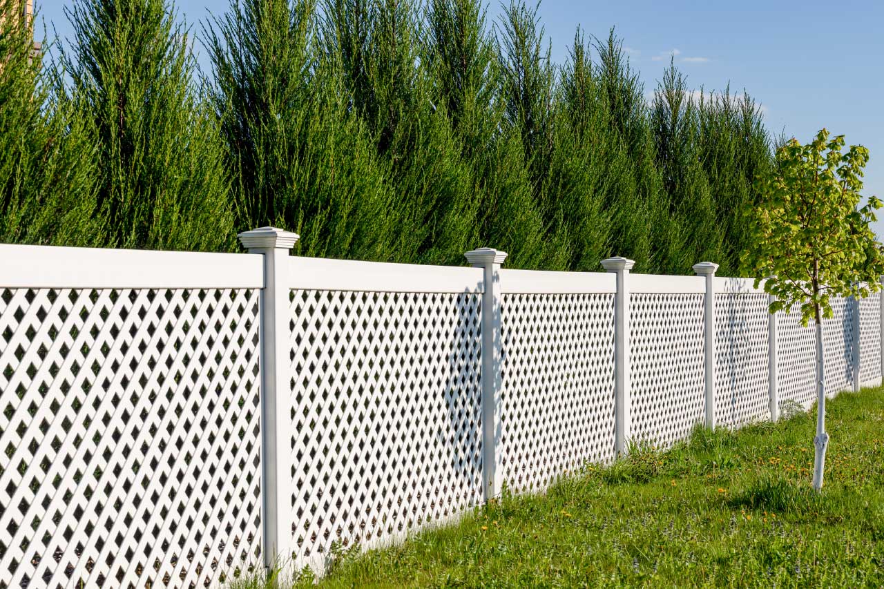 White vinyl fence with green grass