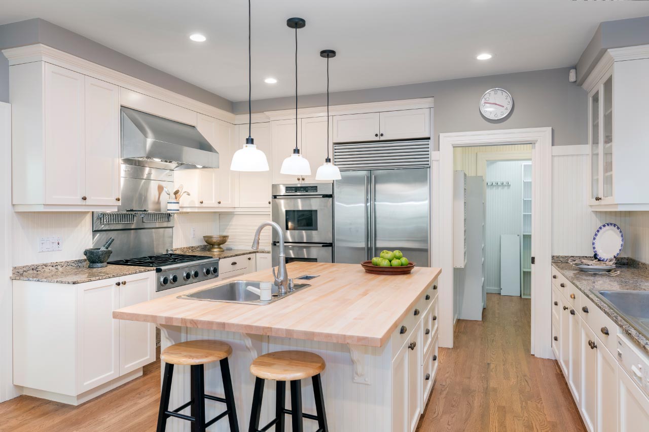 Luxury kitchen interior in white with wooden floor