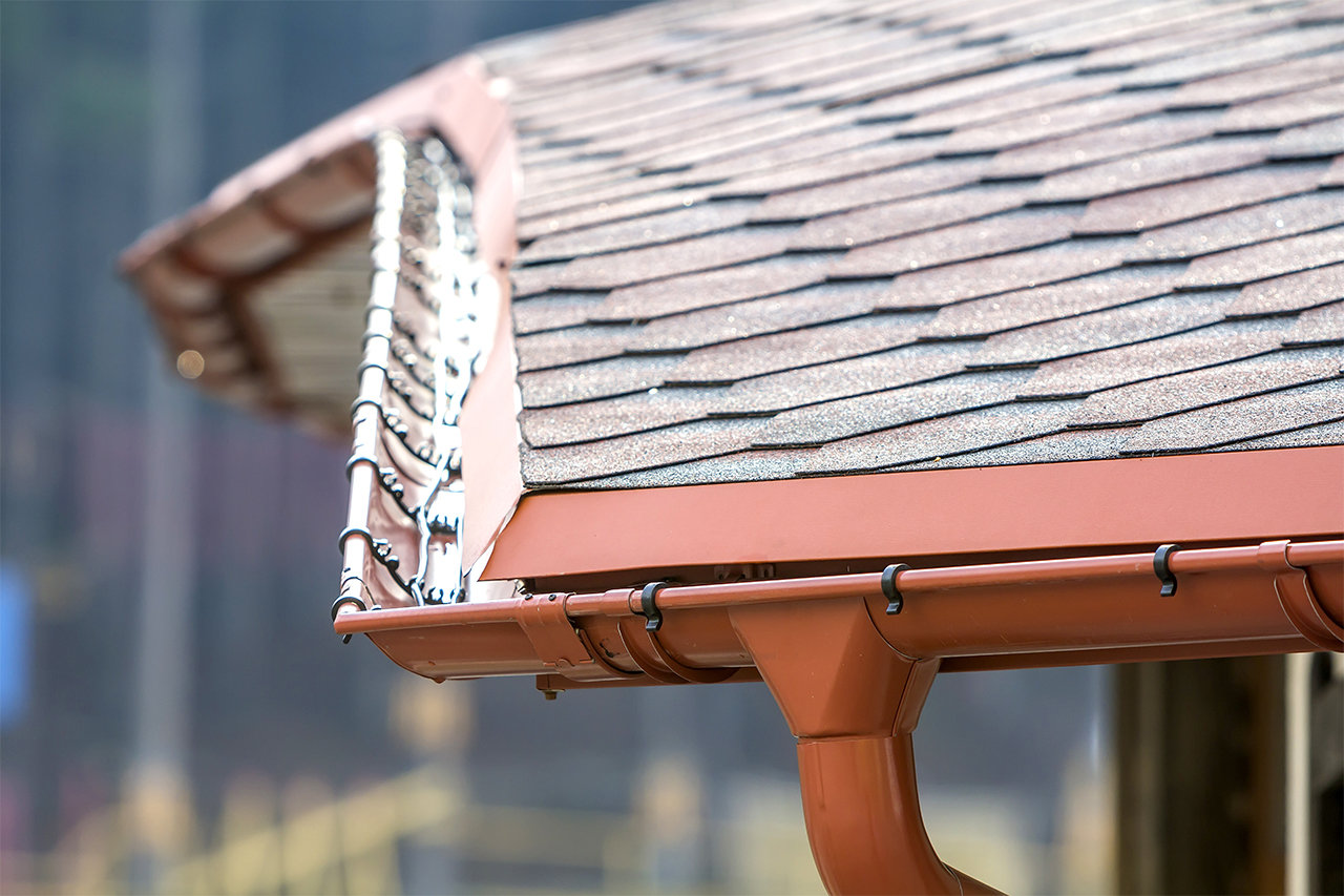 Roof with red aluminum gutters