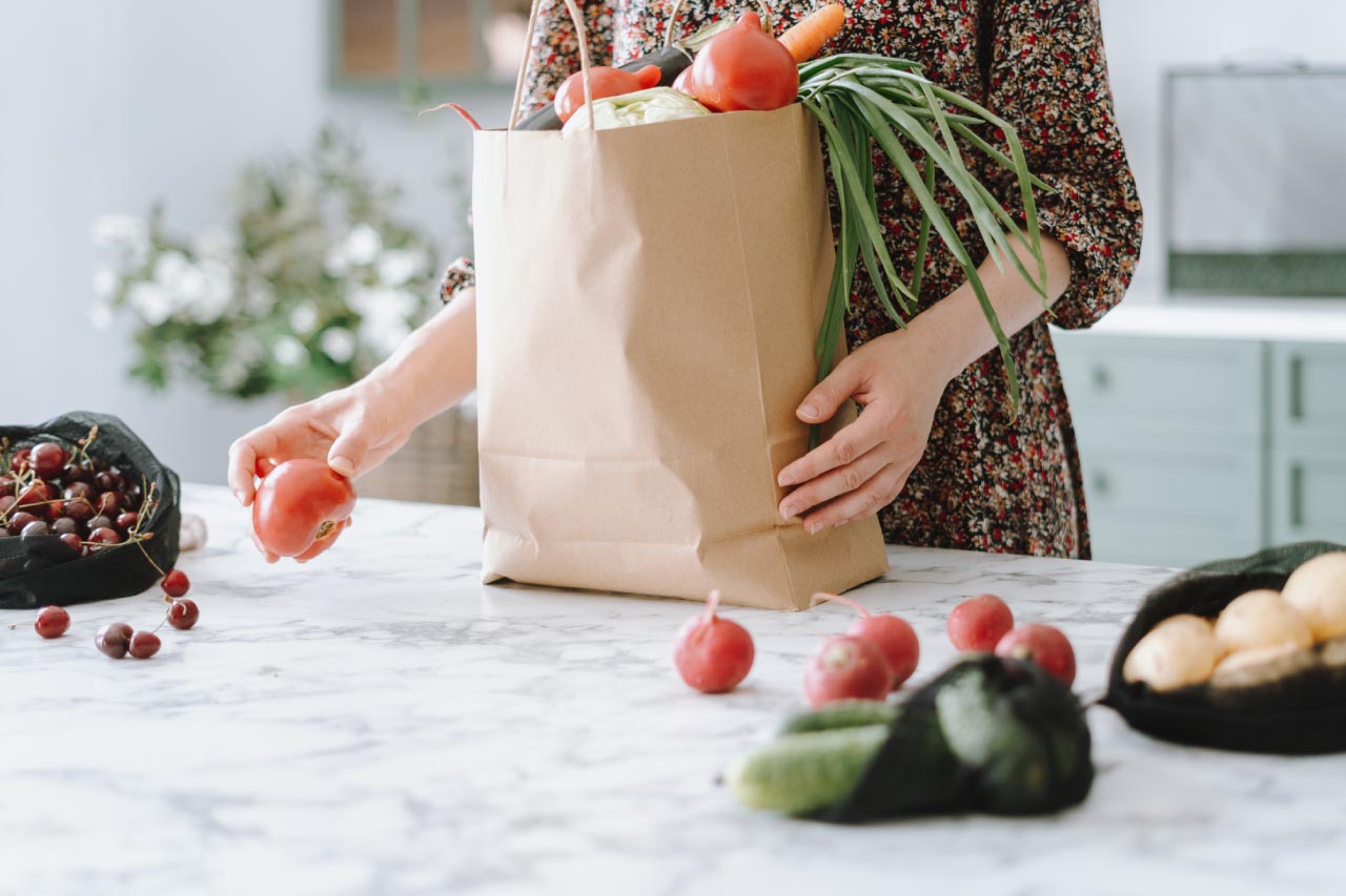 A woman unpacking vegetables