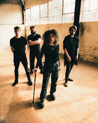 Mallavora band members photoshoot in a white and empty warehouse.