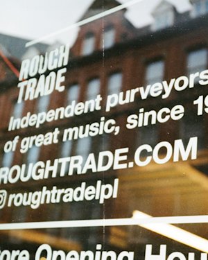 Window with Rough Trade social media information.
