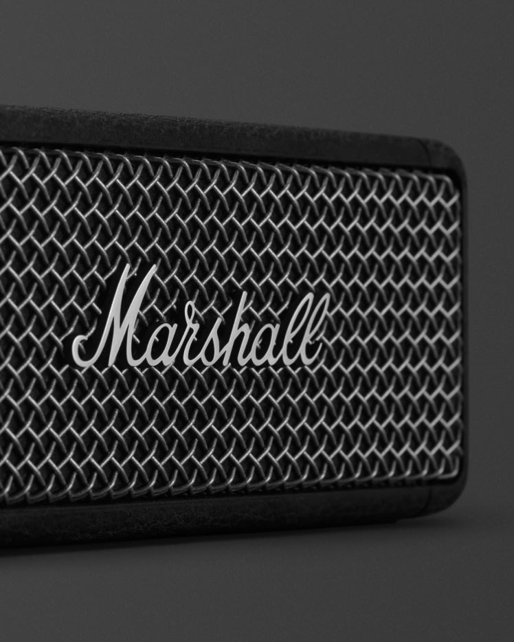 Marshall logo in front of the Marshall Emberton II Black and Brass.