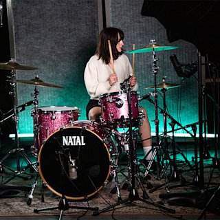 Elaina Nixon playing in a pink set of the Natal Drum kit