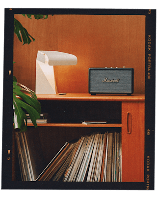 Marshall Acton III Speakers in different colours placed in a vintage living room