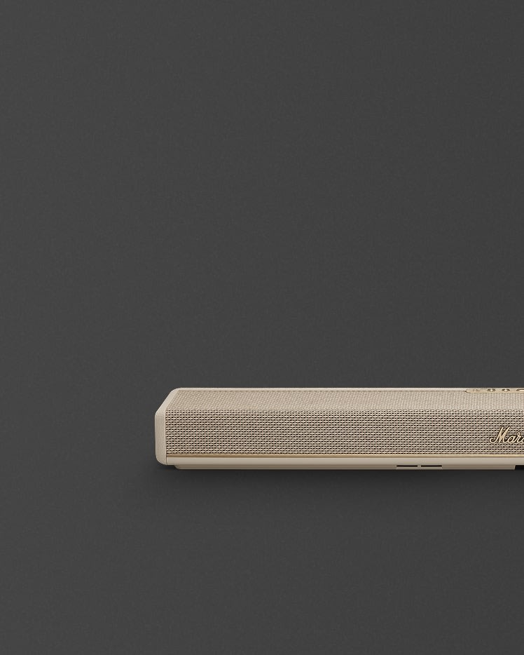 Marshall Heston 60 Cream soundbar, featuring a beige finish, mesh front, and gold logo, stands against a plain dark background with most of the frame left empty.