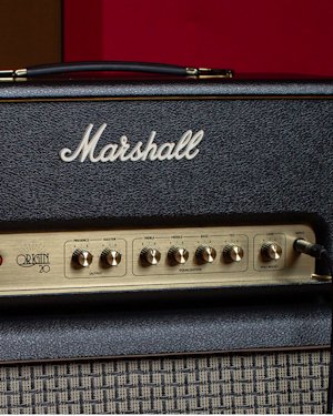 Close-up of a Marshall Origin 20 guitar amplifier, showing control knobs for presence, master, treble, middle, bass, tilt, and gain.