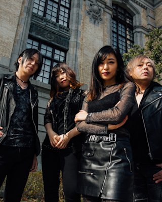 A group of people posing in front of a building.