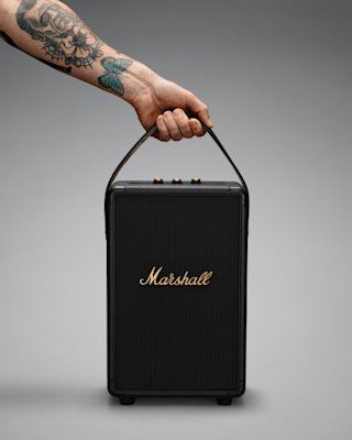 Someone holding a Marshall Tufton speaker with a handle