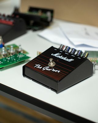 The 'Guv'nor Vintage Reissue Pedal' on top of a desk.