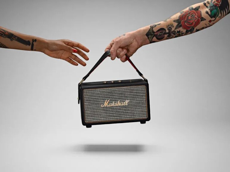 An image of a Marshall speaker being passed from one hand to another.