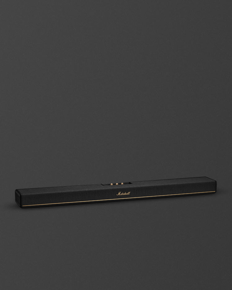 The Marshall Heston 120 soundbar, featuring a sleek black design with gold accents, stands out against a dark grey background.