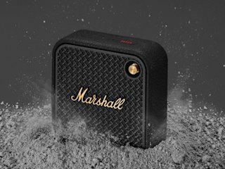 Marshall Willen II Black and Brass bluetooth speaker placed on a dusty surface.