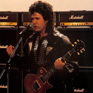 Gary playing guitar in front of a Marshall stack
