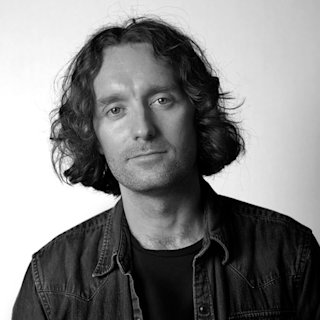 Black and white headshot of David 'Greenie' Green