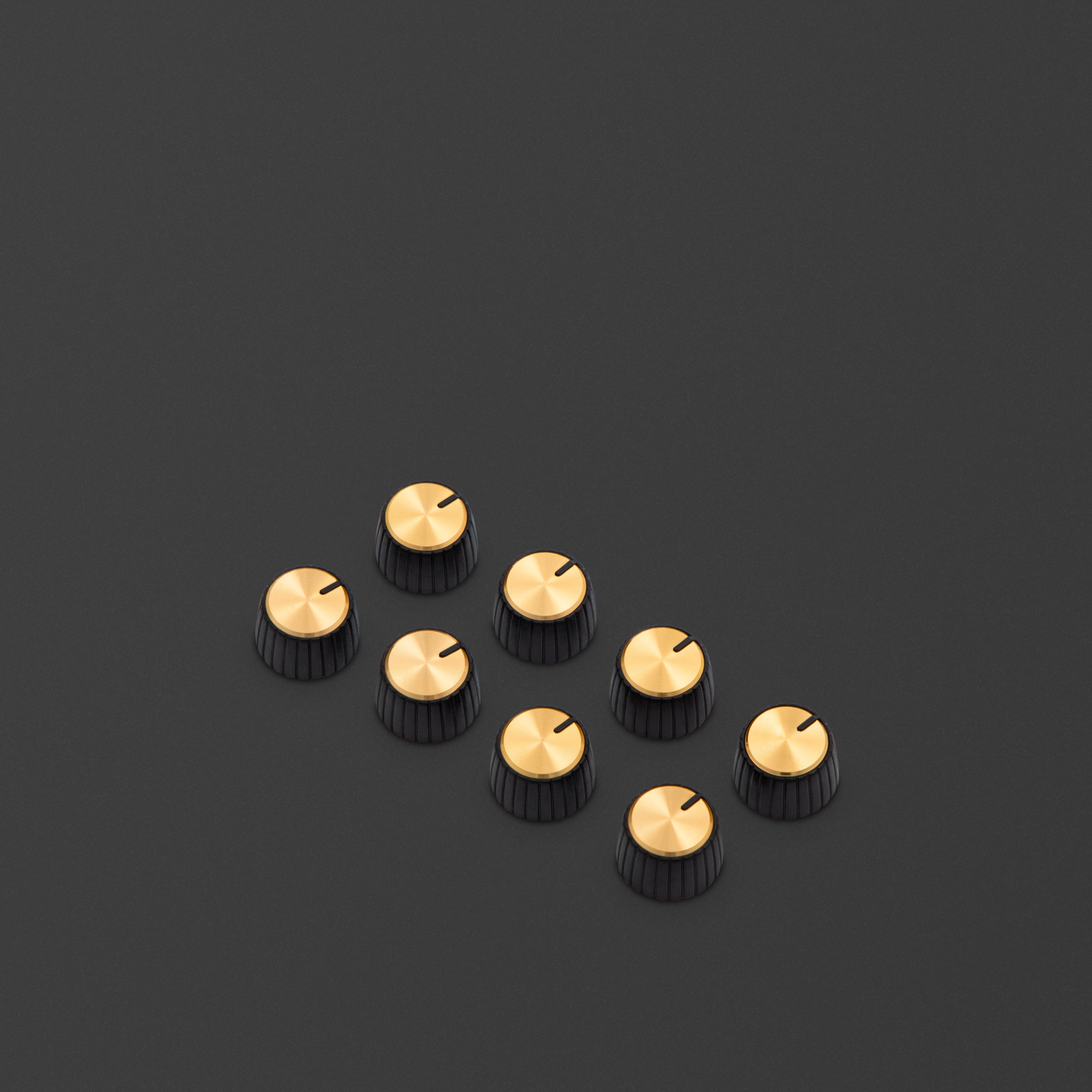 These knobs feature a black body, gold cap, and have a D-shaped push on profile.