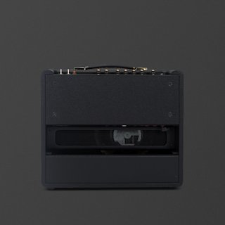 Rear view of a black Marshall Origin20 guitar amplifier combo showing the control panel, handle, and partially visible speaker inside the open back.